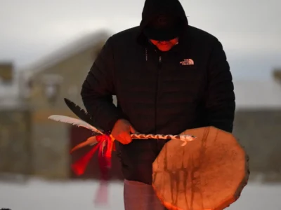 A man sings and plays a drum before the recreation of the historic Fort Snelling in Fort Snelling, Minneapolis. Native activists are seeking to get the state of Minnesota to give the fort to them.