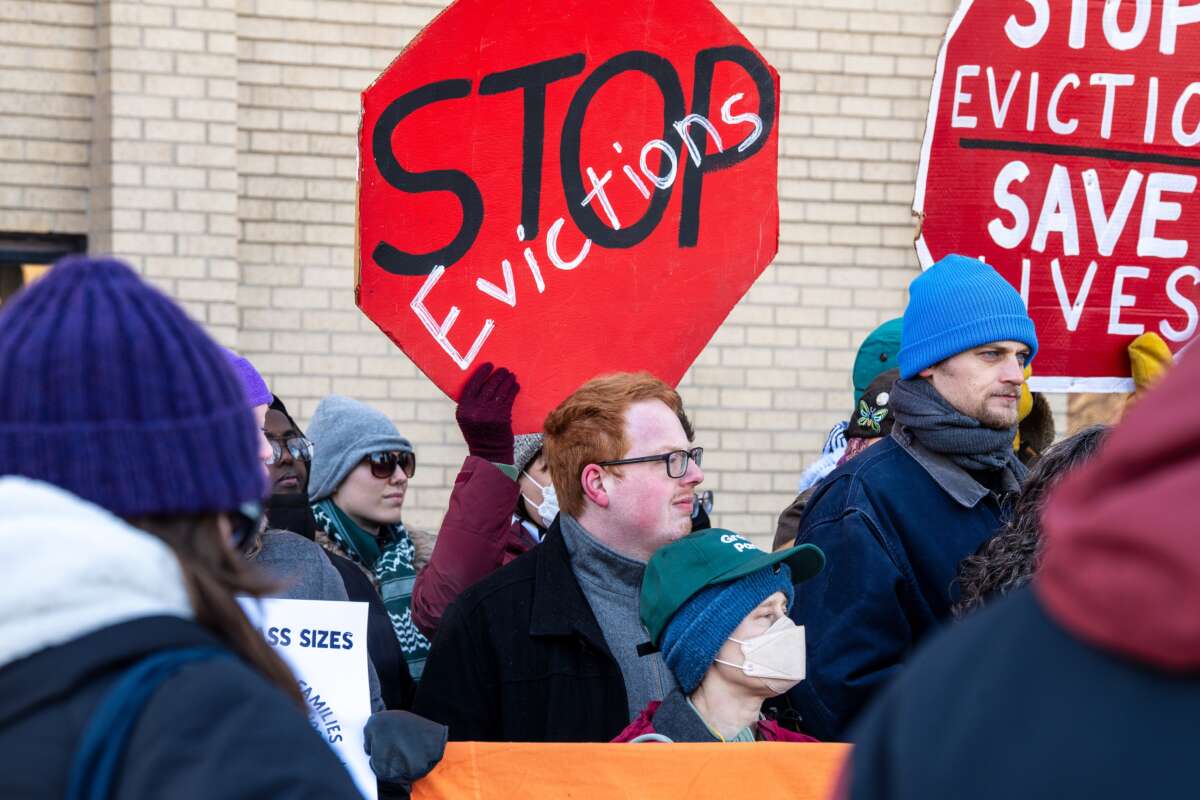 A demonstrator holds a sign reading “Stop evictions, save lives” during a rally calling on Minnesota Gov. Tim Walz to implement an eviction moratorium.