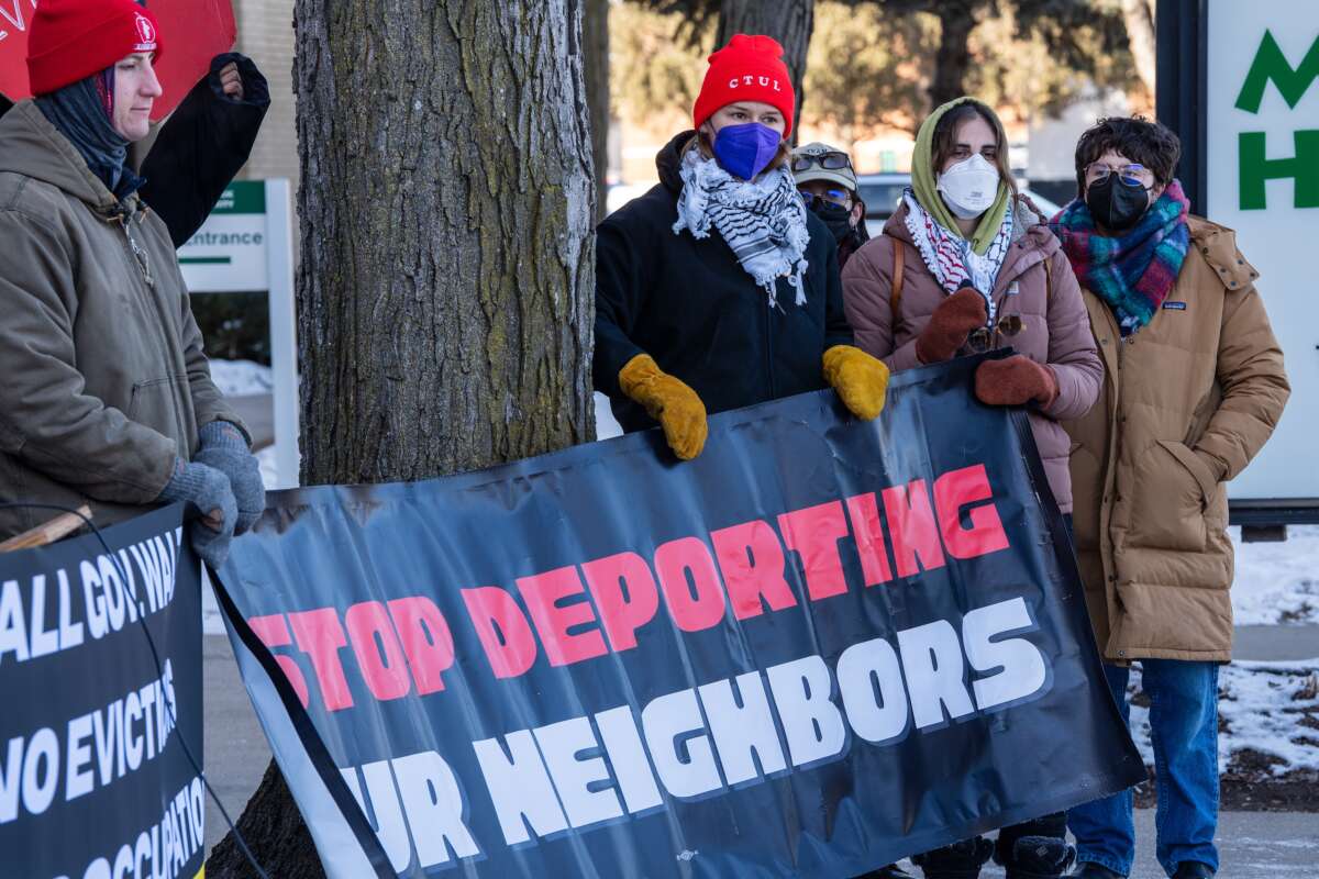 Demonstrators with Centro de Trabajadores Unidos en la Lucha hold a banner reading “Stop deporting our neighbors” during a rally in Minneapolis on January 30, 2026.