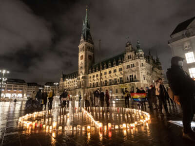 Members of the peace organization International Campaign to Abolish Nuclear Weapons demonstrate with a light action on the first anniversary of the entry into force of the Treaty on the Prohibition of Nuclear Weapons on January 22, 2022, in Hamburg, Germany.