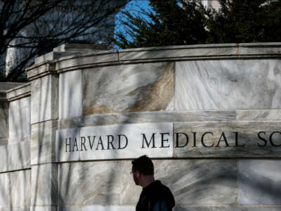 A pedestrian passes Harvard Medical School in Boston, Massachusetts, on April 17, 2025.