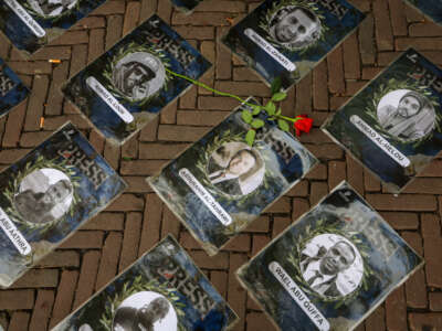 A general view of photos of journalists killed in Gaza laid out in Domblin Square during the "International Day to End Impunity for Crimes against Journalists" on November 2, 2025, in Utrecht, Netherlands.