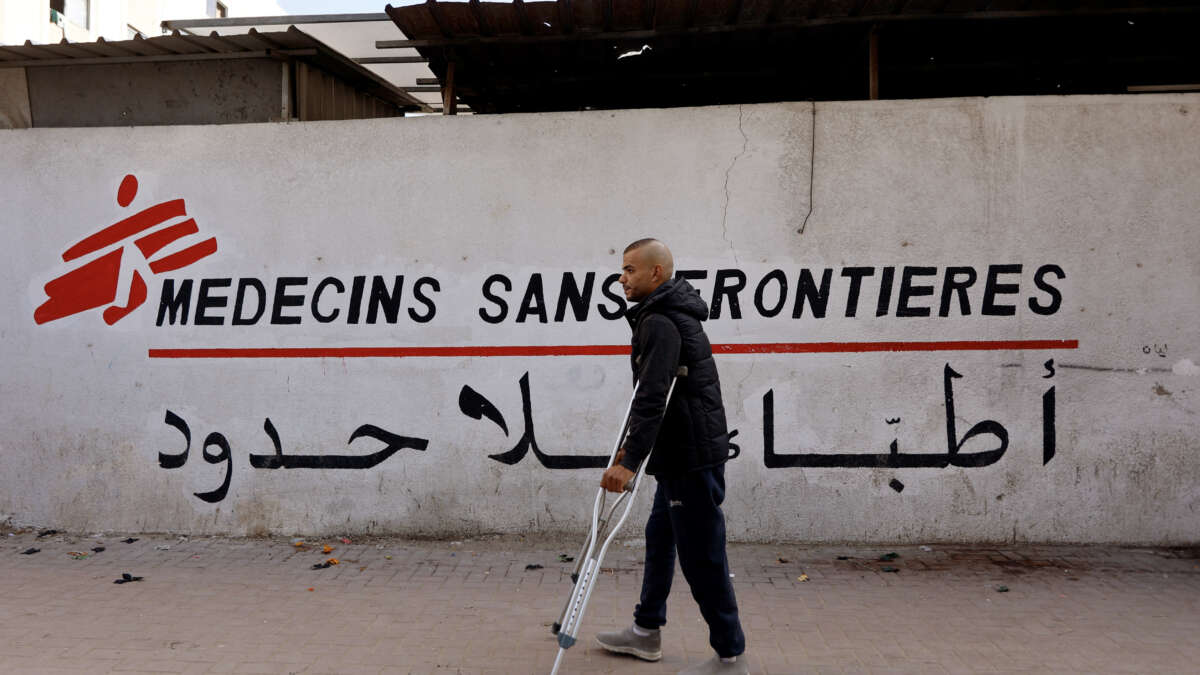 A Palestinian man walks on his crutches to the Doctors Without Borders or Medecins Sans Frontieres (MSF) clinic, in the al-Rimal neighborhood of Gaza City, on December 31, 2025.