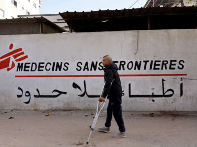 A Palestinian man walks on his crutches to the Doctors Without Borders or Medecins Sans Frontieres (MSF) clinic, in the al-Rimal neighborhood of Gaza City, on December 31, 2025.