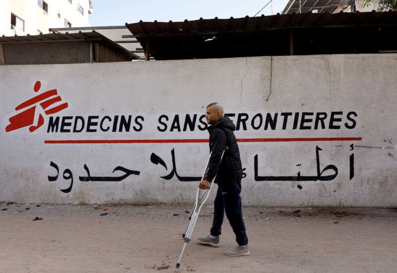 A Palestinian man walks on his crutches to the Doctors Without Borders or Medecins Sans Frontieres (MSF) clinic, in the al-Rimal neighborhood of Gaza City, on December 31, 2025.