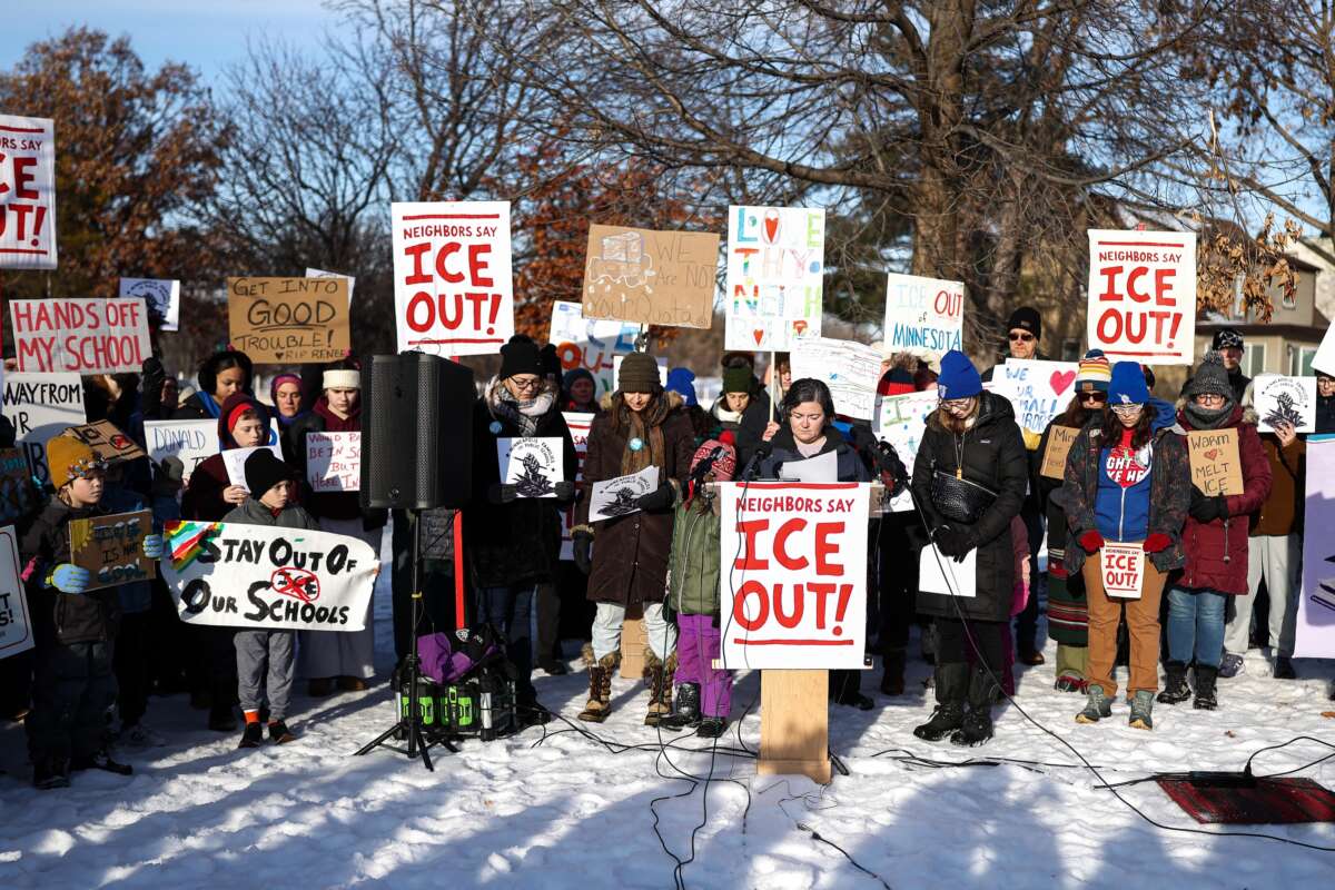 People pause for a minute of silence during a press conference organized by the group "Minneapolis Families for Public Schools," in Minneapolis, Minnesota, on January 9, 2026.