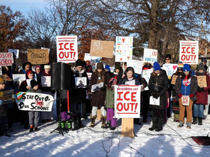 People pause for a minute of silence during a press conference organized by the group "Minneapolis Families for Public Schools," in Minneapolis, Minnesota, on January 9, 2026.