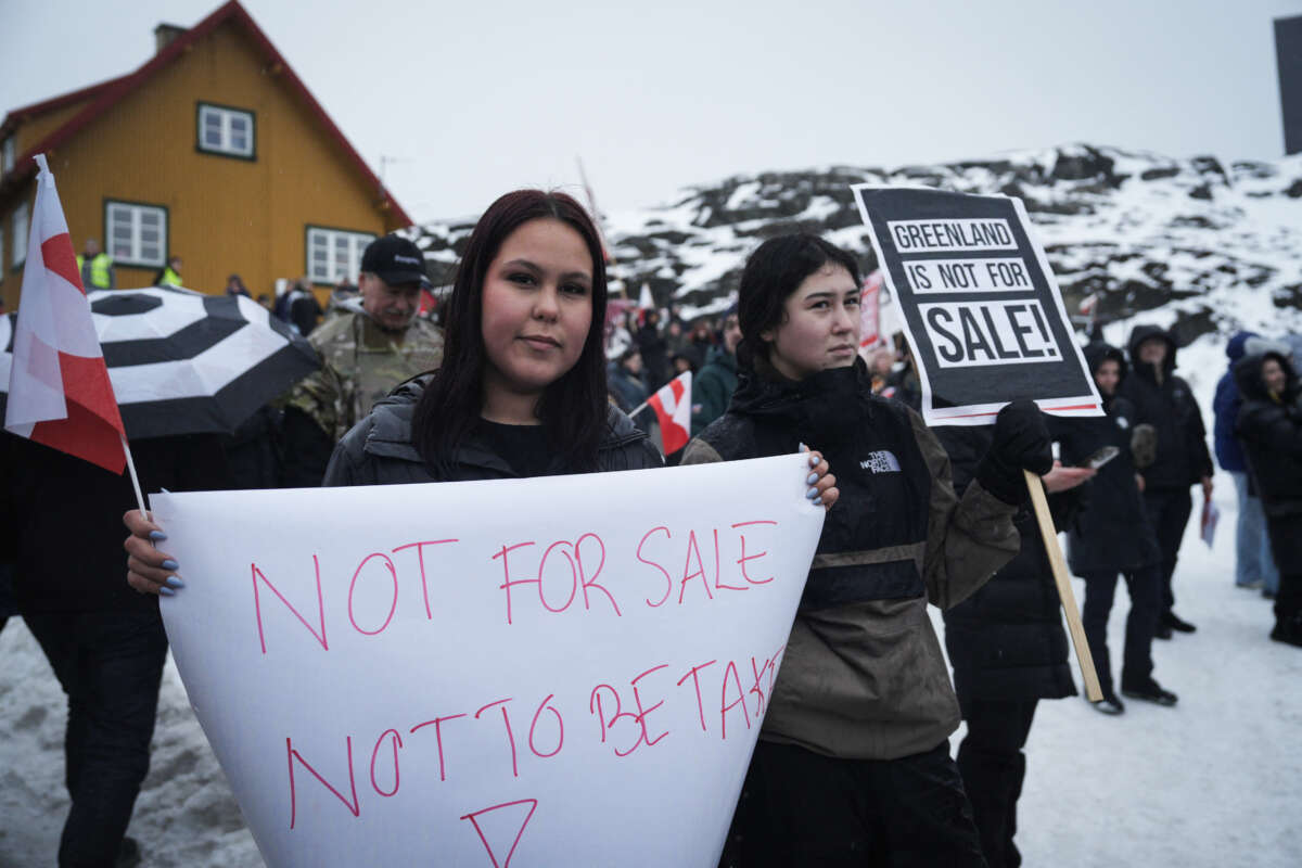 Young people with placards reading "Greenland is not for sale!" take part in a demonstration that gathered almost a third of the city population to protest against the U.S. President's plans to take Greenland, on January 17, 2026, in Nuuk, Greenland, near the U.S. Consulate to Greenland.