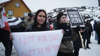 Young people with placards reading "Greenland is not for sale!" take part in a demonstration that gathered almost a third of the city population to protest against the U.S. President's plans to take Greenland, on January 17, 2026, in Nuuk, Greenland, near the U.S. Consulate to Greenland.
