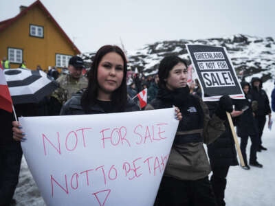 Young people with placards reading "Greenland is not for sale!" take part in a demonstration that gathered almost a third of the city population to protest against the U.S. President's plans to take Greenland, on January 17, 2026, in Nuuk, Greenland, near the U.S. Consulate to Greenland.
