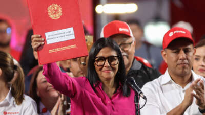 Venezuela's interim President Delcy Rodríguez holds a copy of the Reform of the Organic Law on Hydrocarbons outside the Miraflores Presidential Palace in Caracas, Venezuela, on January 29, 2026. Venezuela adopted a reform opening its nationalized oil sector to private investment on January 29 as it moves to appease the United States following the kidnapping of leader Nicolas Maduro.