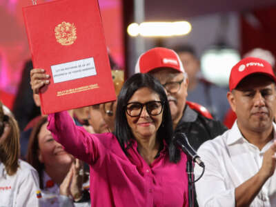 Venezuela's interim President Delcy Rodríguez holds a copy of the Reform of the Organic Law on Hydrocarbons outside the Miraflores Presidential Palace in Caracas, Venezuela, on January 29, 2026. Venezuela adopted a reform opening its nationalized oil sector to private investment on January 29 as it moves to appease the United States following the kidnapping of leader Nicolas Maduro.