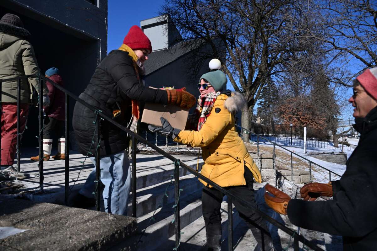 People prepare food packages for immigrants at the Dios Habla Hoy church, which has become a nerve center for locals opposing immigration raids, in Minneapolis, Minnesota, on January 30, 2026.