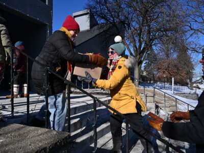 People prepare food packages for immigrants at the Dios Habla Hoy church, which has become a nerve center for locals opposing immigration raids, in Minneapolis, Minnesota, on January 30, 2026.