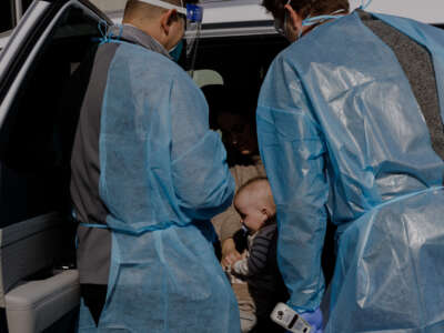 Parkside Pediatrics health care providers Chandler Hash and Nathan Heffington assess a patient with measles symptoms in Spartanburg, South Carolina, on January 30, 2026.