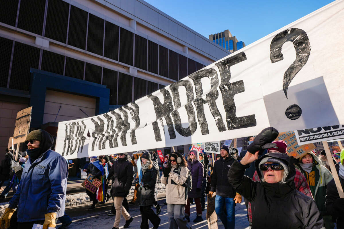 Protesters carry a large banner during a march against Immigration and Customs Enforcement (ICE) in Minneapolis, Minnesota, on January 30, 2026.