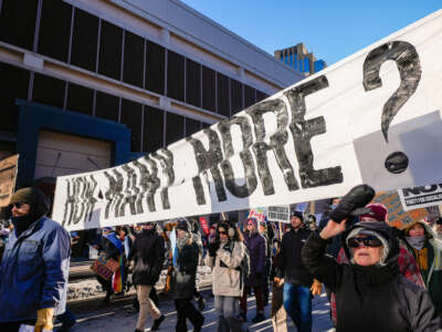 Protesters carry a large banner during a march against Immigration and Customs Enforcement (ICE) in Minneapolis, Minnesota, on January 30, 2026.