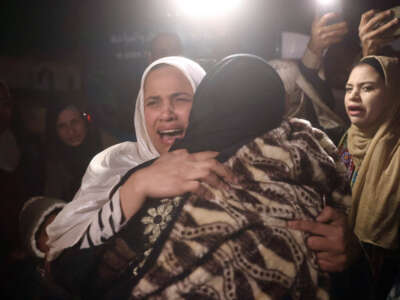 Palestinian women, coming from the Rafah crossing with Egypt, hug as they arrive at Nasser Hospital in Khan Yunis in the southern Gaza Strip, on February 4, 2026.
