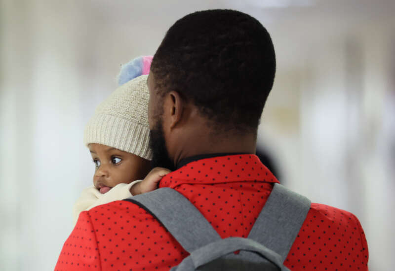A person holding a baby leaves a waiting room after a cancellation of their appointment in immigration court at the Jacob K. Javits Federal Building on February 4, 2026, in New York City.