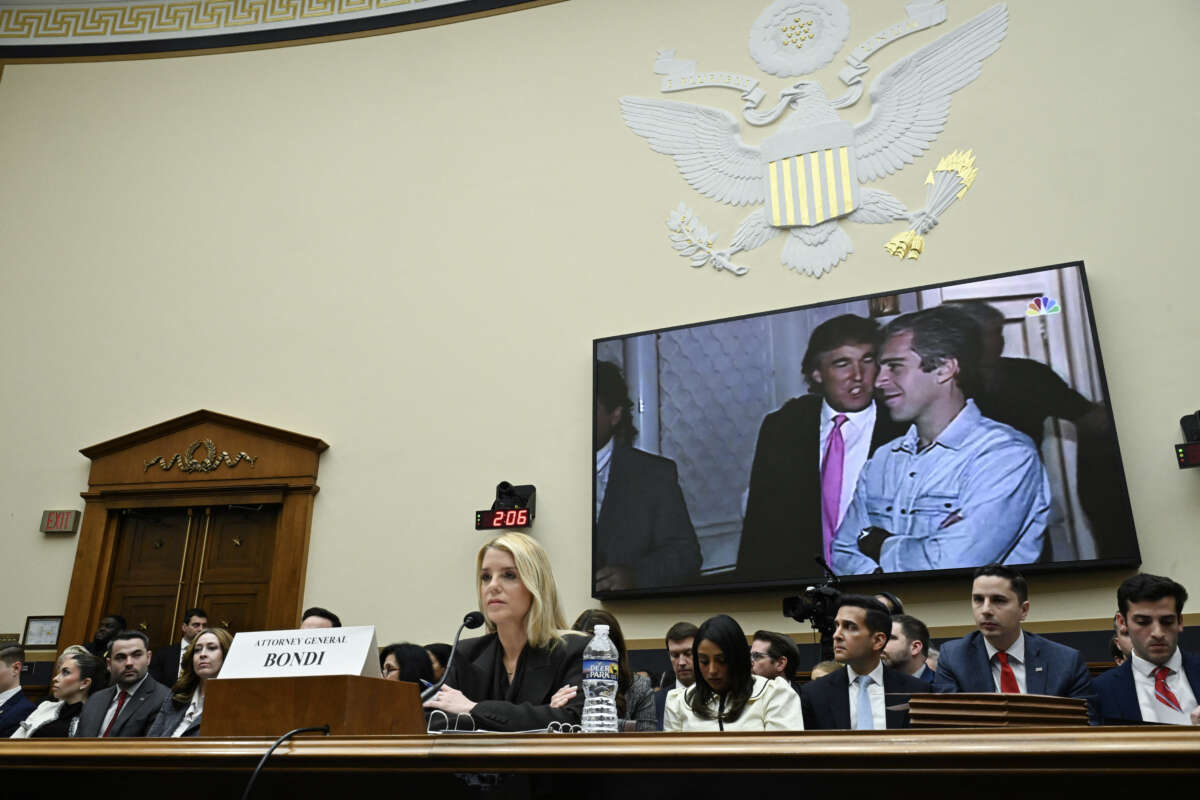 A photo of U.S. President Donald Trump and Jeffrey Epstein is displayed as U.S. Attorney General Pam Bondi testifies during a House Judiciary Committee hearing on "Oversight of the Department of Justice" on Capitol Hill in Washington, D.C., on February 11, 2026.