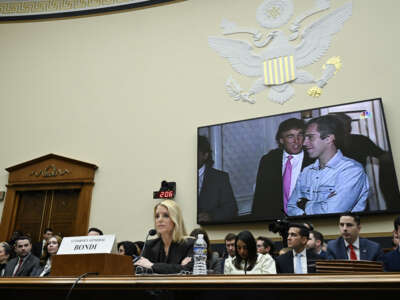 A photo of U.S. President Donald Trump and Jeffrey Epstein is displayed as U.S. Attorney General Pam Bondi testifies during a House Judiciary Committee hearing on "Oversight of the Department of Justice" on Capitol Hill in Washington, D.C., on February 11, 2026.