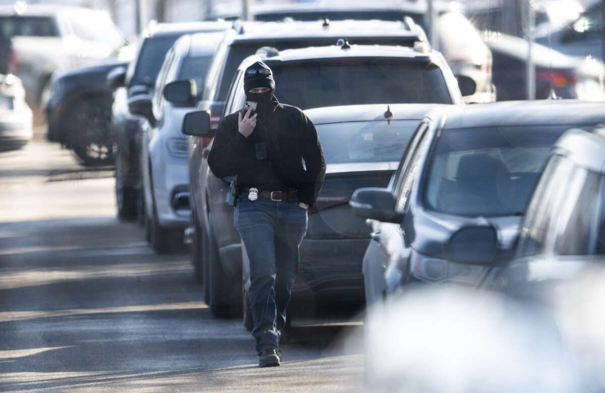 An ICE agent walks to a vehicle outside the Bishop Henry Whipple Federal Building on February 12, 2026, in Minneapolis, Minnesota.