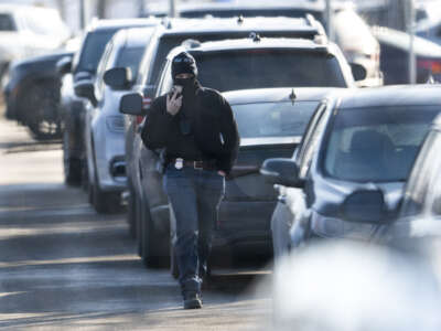 An ICE agent walks to a vehicle outside the Bishop Henry Whipple Federal Building on February 12, 2026, in Minneapolis, Minnesota.