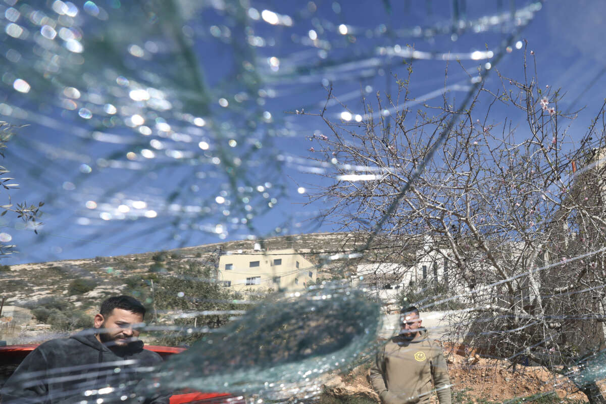 Palestinian men inspect one of several vehicles vandalized by Jewish settlers, who entered the Palestinian village of Telfit, south of the Israeli-occupied West Bank city of Nablus, on February 13, 2026. The latest violence came days after Israel's security cabinet approved measures to tighten control over the West Bank, paving the way for further settlement expansion.