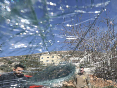 Palestinian men inspect one of several vehicles vandalized by Jewish settlers, who entered the Palestinian village of Telfit, south of the Israeli-occupied West Bank city of Nablus, on February 13, 2026. The latest violence came days after Israel's security cabinet approved measures to tighten control over the West Bank, paving the way for further settlement expansion.