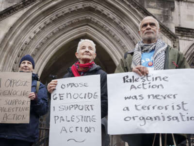 Supporters of Palestine Action celebrate outside the Royal Courts of Justice after the High Court ruled that the group's banning by the government under terrorism legislation is unlawful, on February 13, 2026, in London, England.