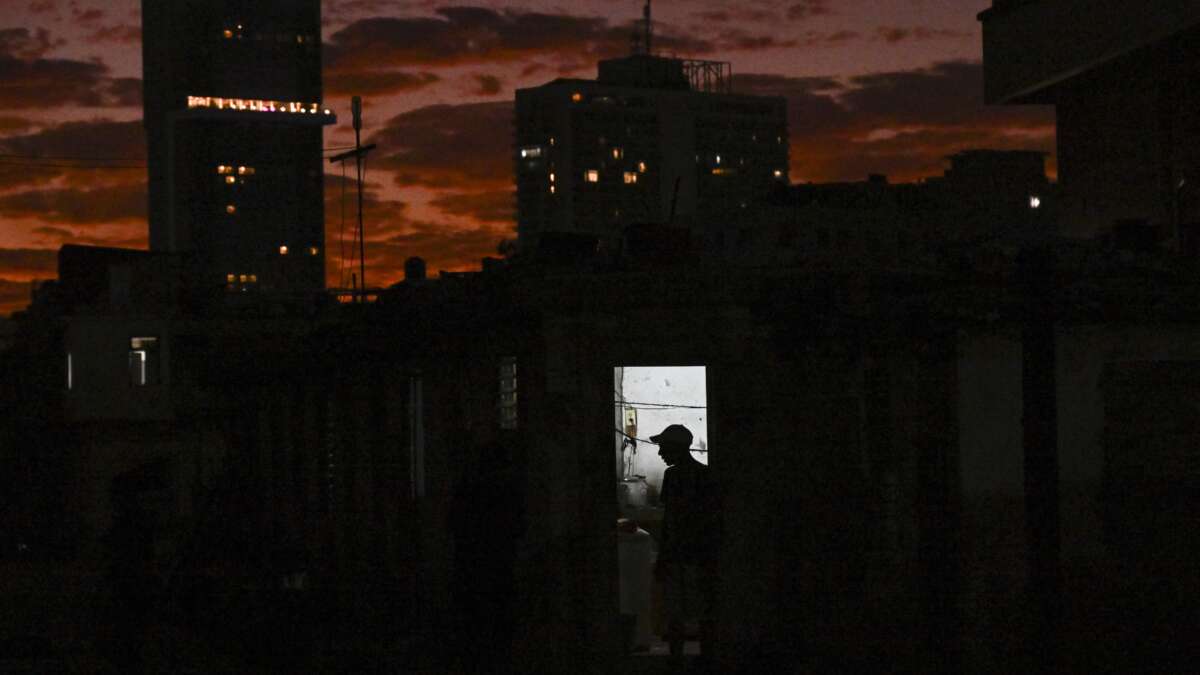 The silhouette of a man is seen at his home during a blackout in Havana, Cuba, on February 21, 2026. On February 23, Cuban Foreign Minister Bruno Rodríguez Parrilla said the United States was trying to trigger a "humanitarian catastrophe" in his country with an oil blockade he called an "aggressive escalation."