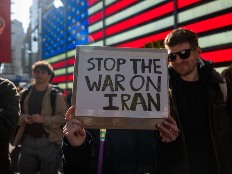 People gather in Times Square as the nation reacts to "major combat operations" in Iran on February 28, 2026, in New York City.