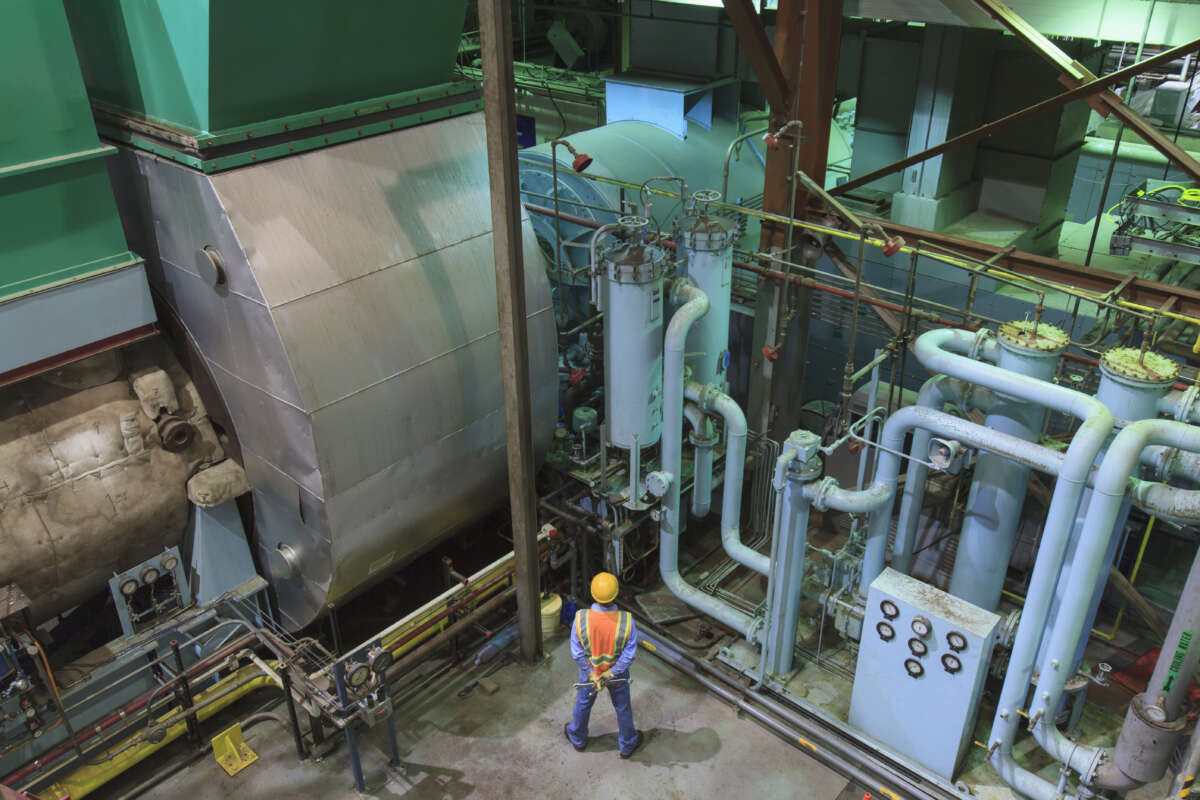 Engineer in gas turbine electric power plant exhaust gas and condensation process room