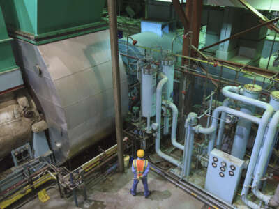Engineer in gas turbine electric power plant exhaust gas and condensation process room