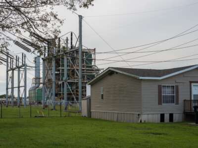 A house sits along the long stretch of River Road by the Mississippi River and the many chemical plants in Baton Rouge, Louisiana, on October 12, 2013. “Cancer Alley” stretches from New Orleans to Baton Rouge, where a dense concentration of oil refineries, petrochemical plants, and other chemical industries reside alongside suburban homes.