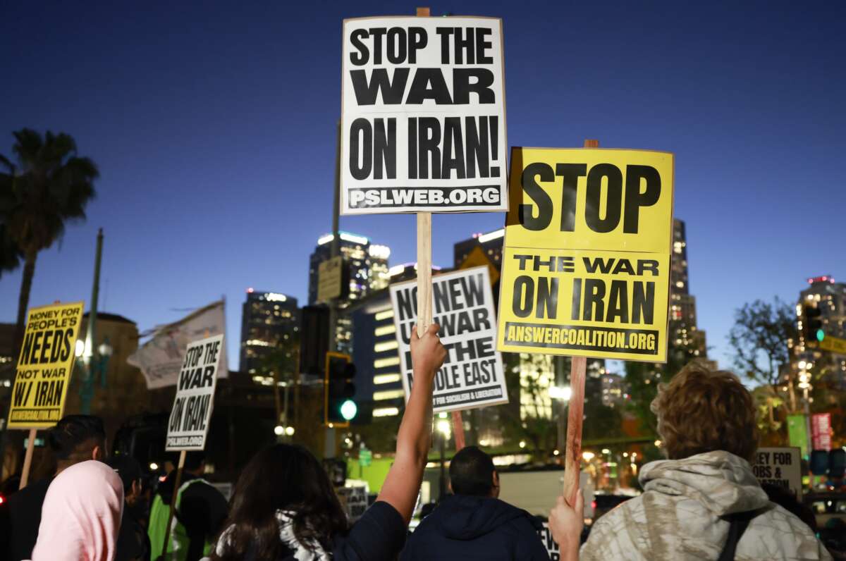 Demonstrators hold signs during a protest outside City Hall against the U.S. and Israel's attack on Iran on March 02, 2026 in Los Angeles, California.