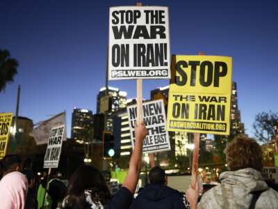 Demonstrators hold signs during a protest outside City Hall against the U.S. and Israel's attack on Iran on March 02, 2026 in Los Angeles, California.