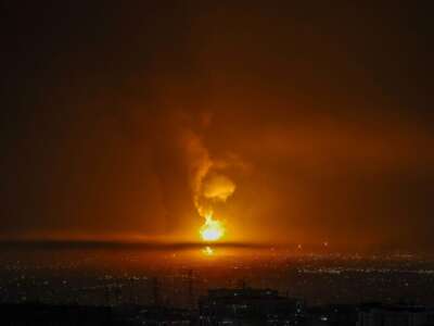 Smoke and flames rise at the site of airstrikes on an oil depot in Tehran on March 7, 2026.
