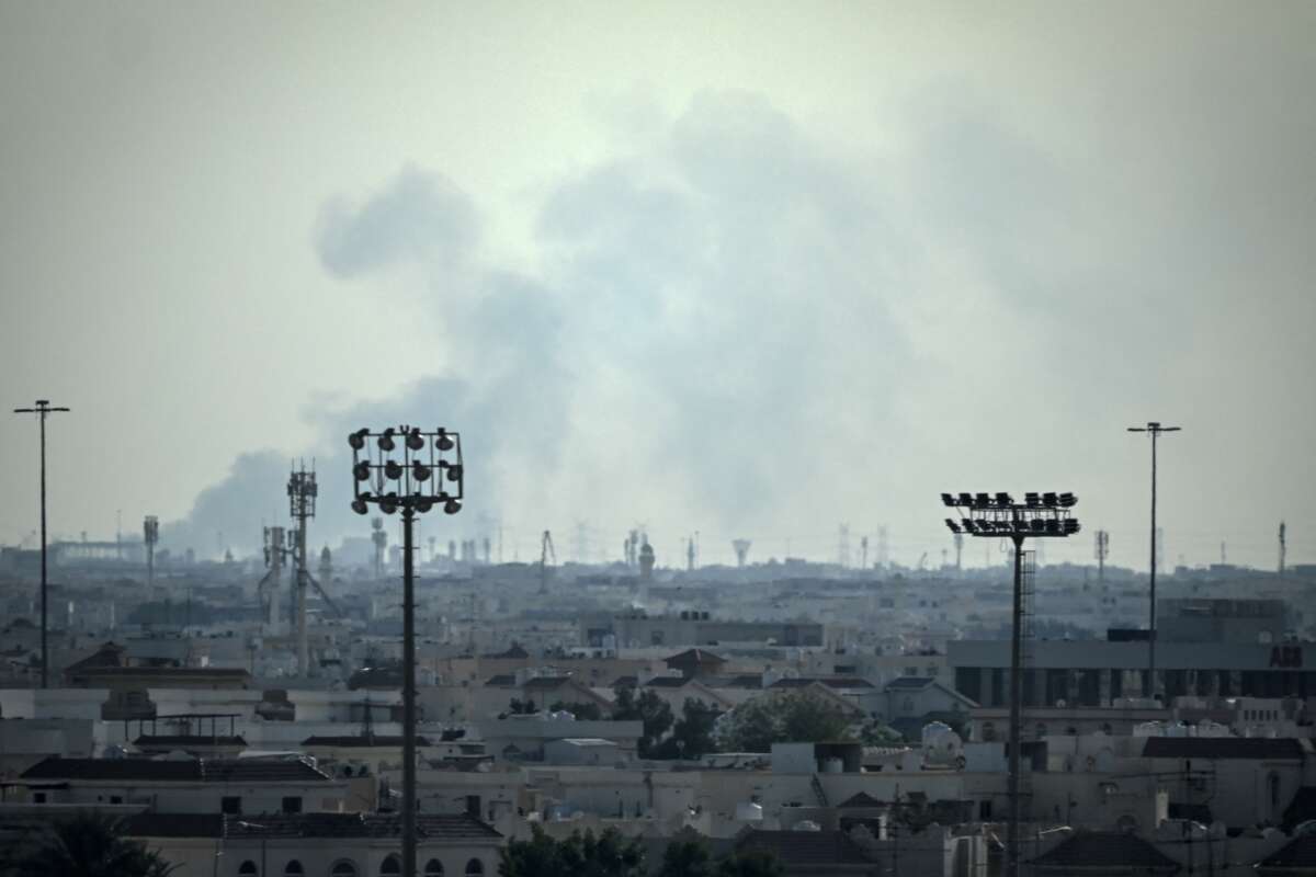 Smoke rises from an area in the direction of Al Udeid Air Base, which houses the Qatar Emiri Air Force and foreign forces including the U.S., in Doha on February 28, 2026, following a reported Iranian strike.