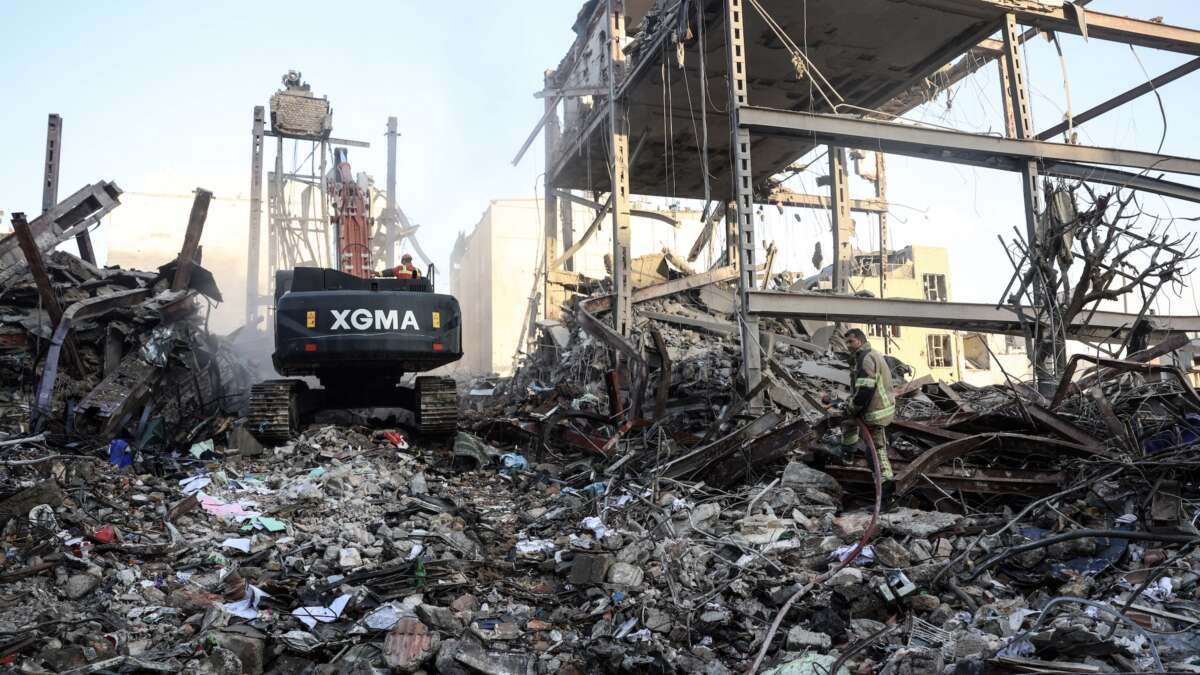 A firefighter stands on the rubble of residential buildings near Niloufar square in Tehran during the ongoing joint U.S.-Israeli military campaign on Iran on March 2, 2026.