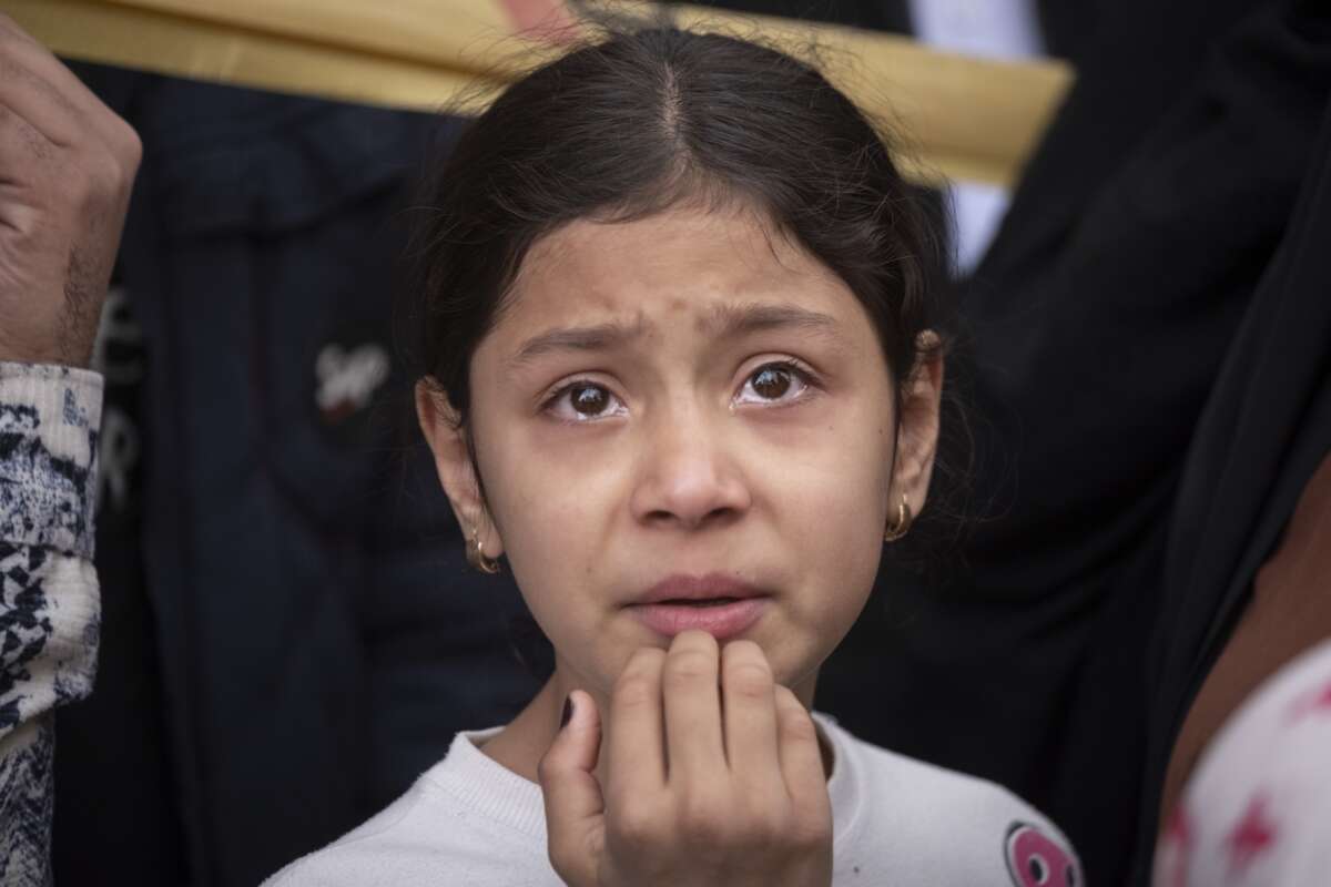 A young girl cries as she stands in an area affected during the United States-Israeli military operations in Tehran, Iran, on March 27, 2026.