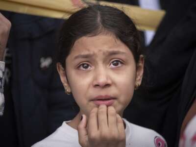 A young girl cries as she stands in an area affected during the United States-Israeli military operations in Tehran, Iran, on March 27, 2026.