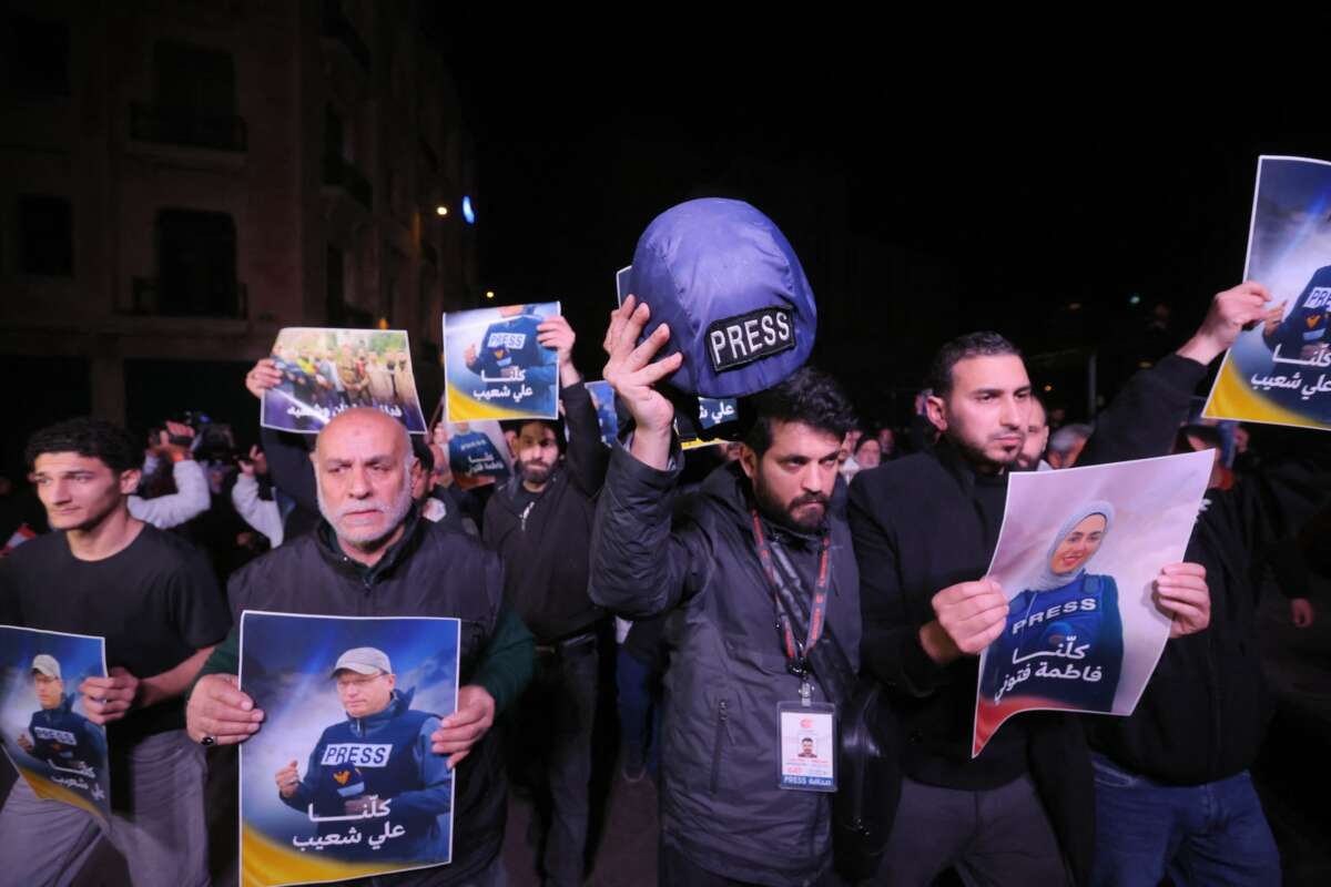 People hold pictures of Fatima Ftouni and Ali Shoaib in downtown Beirut, as they protest their killing from an Israeli strike that targeted their vehicle on a road leading to Jezzine in southern Lebanon on March 28, 2026.