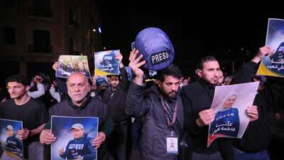 People hold pictures of Fatima Ftouni and Ali Shoaib in downtown Beirut, as they protest their killing from an Israeli strike that targeted their vehicle on a road leading to Jezzine in southern Lebanon on March 28, 2026.