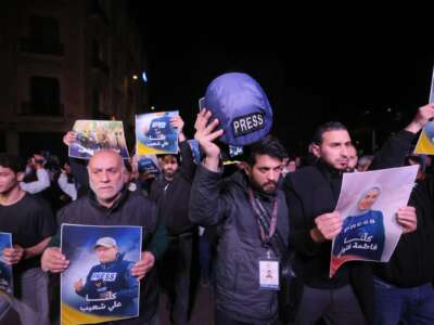 People hold pictures of Fatima Ftouni and Ali Shoaib in downtown Beirut, as they protest their killing from an Israeli strike that targeted their vehicle on a road leading to Jezzine in southern Lebanon on March 28, 2026.
