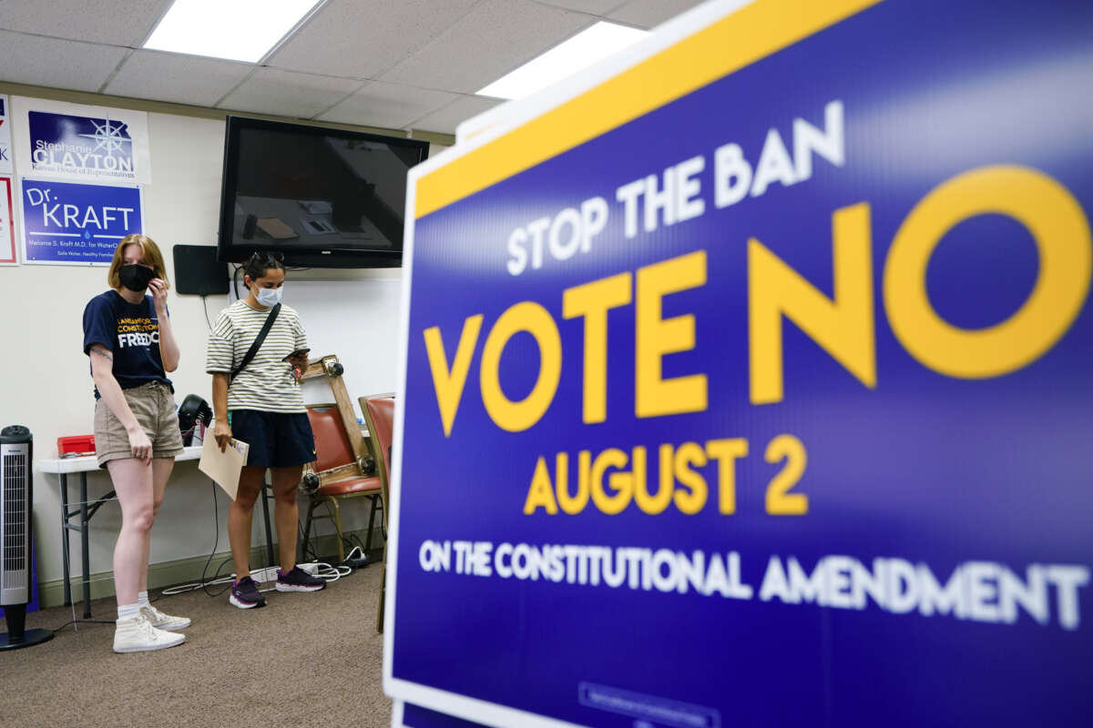 A canvasser for the Vote No on the Constitutional Amendment on Abortion is given their route by organizer Jae Gray at the Johnson County Democratic Office on August 1, 2022, in Overland Park, Kansas.