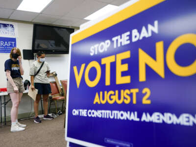 A canvasser for the Vote No on the Constitutional Amendment on Abortion is given their route by organizer Jae Gray at the Johnson County Democratic Office on August 1, 2022, in Overland Park, Kansas.