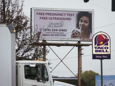 A billboard advertises a crisis pregnancy center that is located across the street from Whole Woman's Health of South Bend, Indiana, on October 29, 2021.