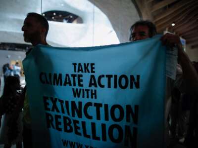 Climate activists with the group Extinction Rebellion protest inside the Museum of Natural History in New York City, on August 18, 2024.