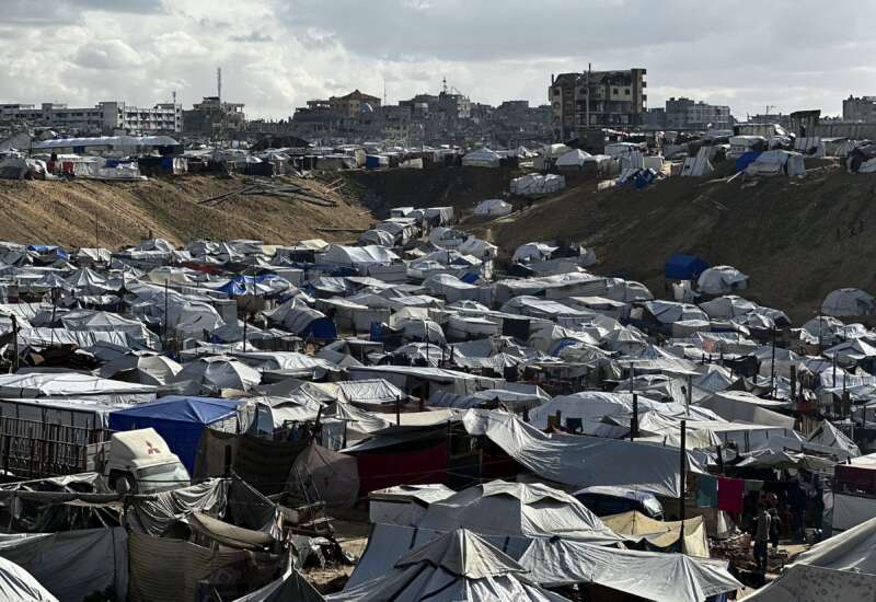 Dozens of makeshift tents stretch across a flooded and muddy landscape in the Al-Mawasi area of the Gaza Strip on November 25, 2025. Heavy rainfall and a strong weather front caused severe flooding across the area submerging roads, damaging tents, and disrupting movement for displaced families.